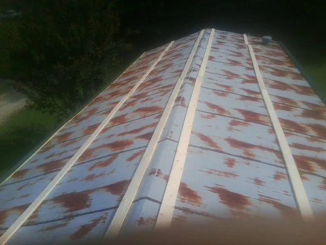 Rusted metal roof panels with new wood purlins before replacement — Storm Damage Roof Repair in Mission by Roofing Brothers
